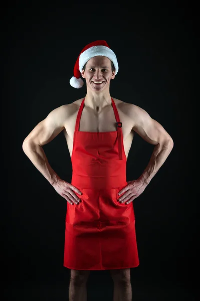 Let me cook for you. Muscular man wear santa claus hat. Bodybuilder on black background. Winter holidays. Muscular sportsman celebrate new year. Christmas spirit. Christmas tradition. Merry christmas