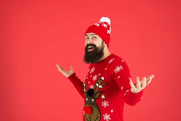 Feast day. wear christmas mood. knitwear male fashion. funny looking man. new year party. still believe in santa claus. mature bearded man sweater. brutal hipster in knitted hat red background — Stock Photo, Image