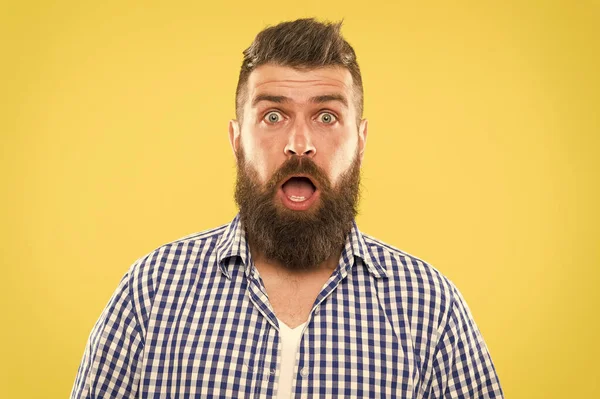 Wondering every time. Man bearded hipster wondering face yellow background close up. Guy surprised face expression. Hipster emotional surprised expression. Rustic surprised macho. Surprising news