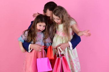 Shopping and presents concept. Girls and man with surprised faces clipart