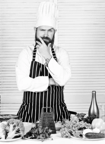 Choosing the freshest veggies for salad. confident bearded man. chef recipe. Dieting organic food. Cuisine culinary. Vitamin. Healthy food cooking. Mature hipster with beard