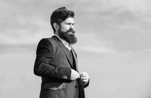 Beard fashion trend. Start with grooming routine and ultimately lead better world. Man bearded hipster wear formal suit blue sky background. Vintage style beard. Facial hair beard and mustache care