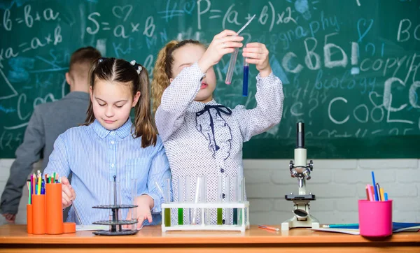 Explore biological molecules. Future technology and science concept. Kids in classroom with microscope and test tubes. Children study biology or chemistry school. School education. School girls study — Stock Photo, Image