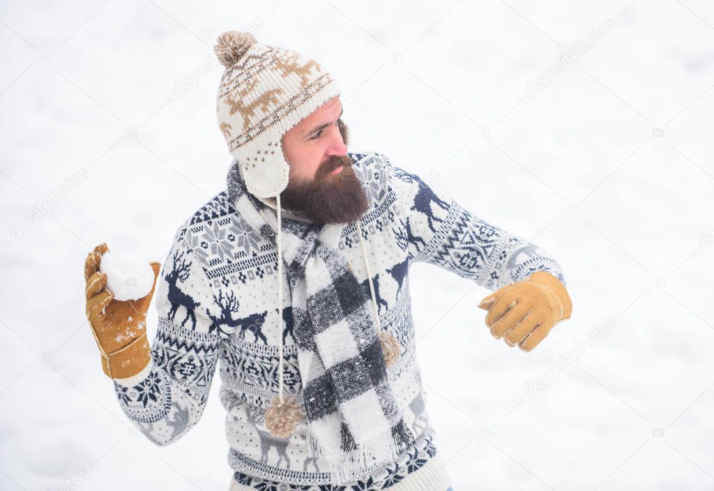 happy hipster play snowballs. winter season. Christmas snow activity. winter holiday. Morning before xmas. man having fun outdoor. bearded man in warm clothes. Happy new year. Warm smiles
