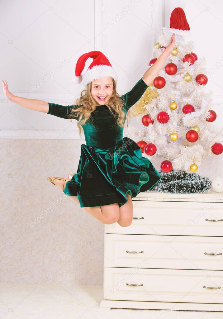 Day we have waited for all year finally here. Girl excited about christmas jump mid air. Child emotional cant stop her feelings. Celebrate christmas concept. Girl in dress jumping. It is christmas