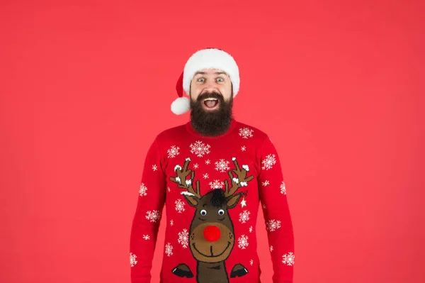 Check out my sweater. Happy new year. Join holiday party. Winter party outfit. Invitation ugly sweaters party. Sweater with deer. Hipster bearded man wear winter sweater and hat red background