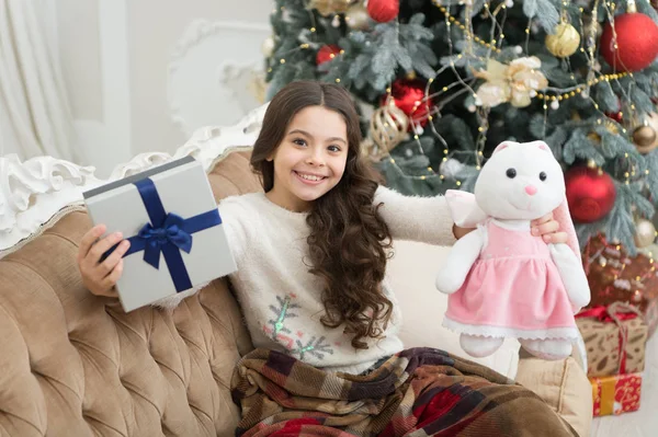Unexpected surprise. xmas presents at kid shop. small girl love her bunny. best christmas toy gift. happy kid find presents at christmas tree. feeling cosy at home. happy new year mood. cheer and joy — Stock Photo, Image