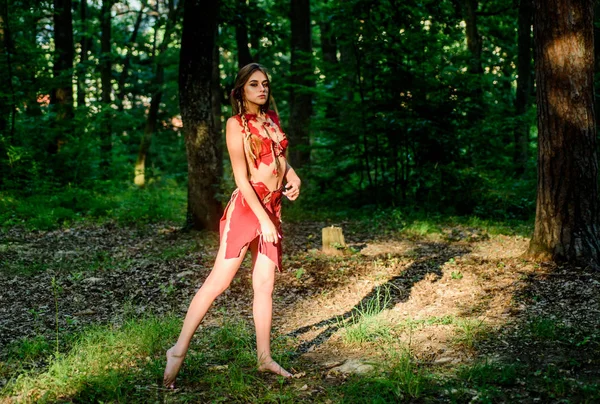 Female spirit mythology. Forest fairy. Living wild life untouched nature. Wild woman in forest. Sexy girl early stage in the evolutionary development. Culture of wild human. Fashion primitive design