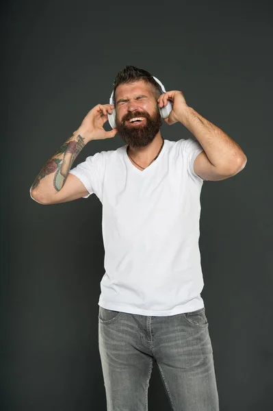 King of sound, play it loud. Bearded man listen to sound track. Hipster enjoy sound of music playing in earphones. Music and technology. Fun and entertainment. Mot all music sound the same