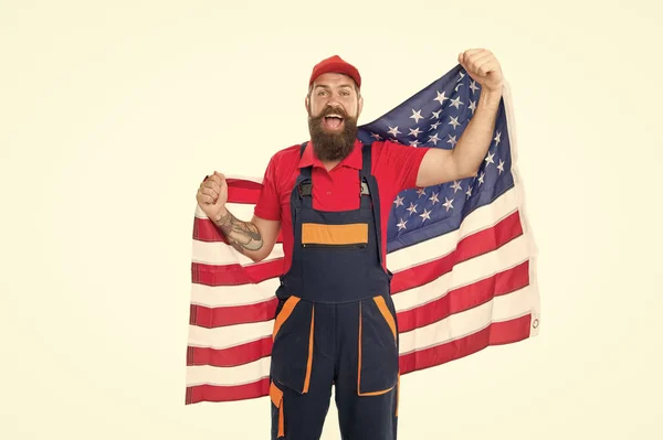 Guy worker uniform. Builder regular worker. Job relocation. Country of opportunities. National holiday. Worker celebrate independence day. Work visa USA. Man hold american flag. Repair and renovation