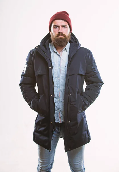 Man bearded hipster posing confidently in warm black jacket or parka. Hipster modern fashion. Guy wear hat and black winter jacket. Hipster style menswear. Hipster outfit. Stylish and comfortable — Stock Photo, Image