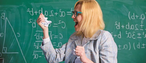 Fed up of fails. Trial and error is fundamental method of problem solving. Teacher screaming face holds pieces of paper with mistakes wrongly solved test. Woman teacher holds crumpled pieces of paper — Stock Photo, Image