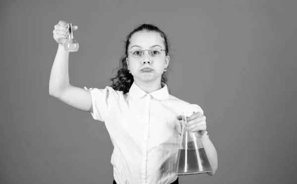 Childhood and upbringing. Knowledge and information. Experimenting a bit. Small kid study. Education concept. Chemistry fun. Basic knowledge. Knowledge day. Schoolgirl with chemical liquids — Stock Photo, Image