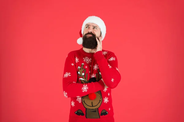 Get Guaranteed Christmas Delivery. winter holiday celebration. dreaming present. bearded man santa hat red wall. christmas time. male at xmas party. happy new 2020 year. funny hipster knitted sweater. — Stock Photo, Image