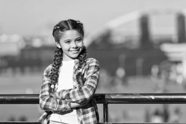 Vacation and leisure. What do on holidays. Sunny day walk. Leisure options. Free time and leisure. Girl cute kid with braids relaxing urban background defocused. Organize activities for teenagers