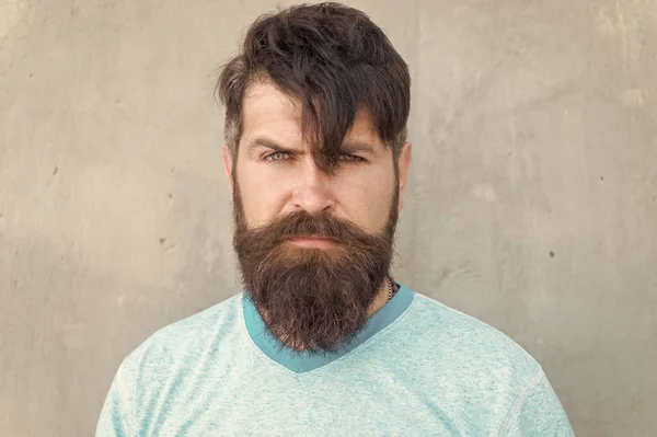 Long hair. Cut bangs. Cool hipster with beard need haircut. Barber salon and facial care. Hipster lifestyle. Brutal handsome mature hipster man. Bearded man trendy style. Beard and mustache grooming