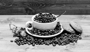 Arabica robusta kahve çeşidini. İlham ve enerji şarjı için içecek. Fincan tam kahve kahverengi kavrulmuş fasulye mavi ahşap arka plan. Taze kavrulmuş kahve çekirdekleri. Kafein konsepti. Cafe içecekler menüsü