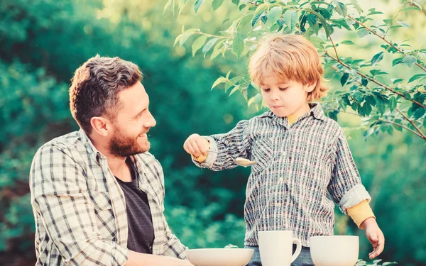 Little boy and dad eat. Organic nutrition. Healthy nutrition concept. Nutrition habits. Family enjoy homemade meal. Personal example. Nutrition kids and adults. Father teach son eat natural food — Stock Photo, Image