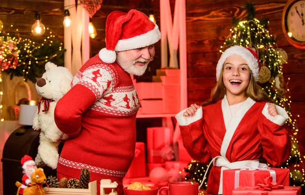 Santa Claus generous. Child enjoy christmas with bearded grandfather Santa claus. Festive tradition. Happiness and joy. Rewarding kindness. Cheerful celebration. Santa bring gifts little girl