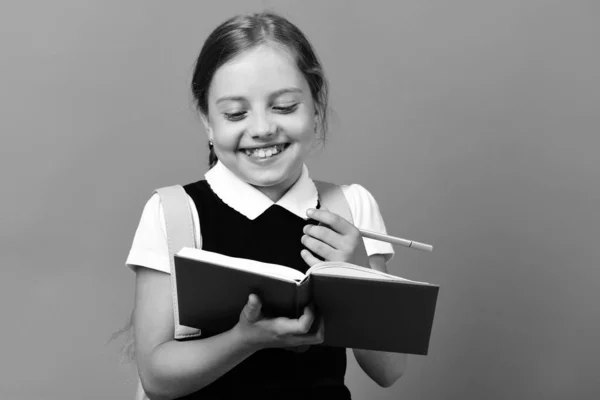 Back to school and education concept. Girl holds blue book — Stock Photo, Image