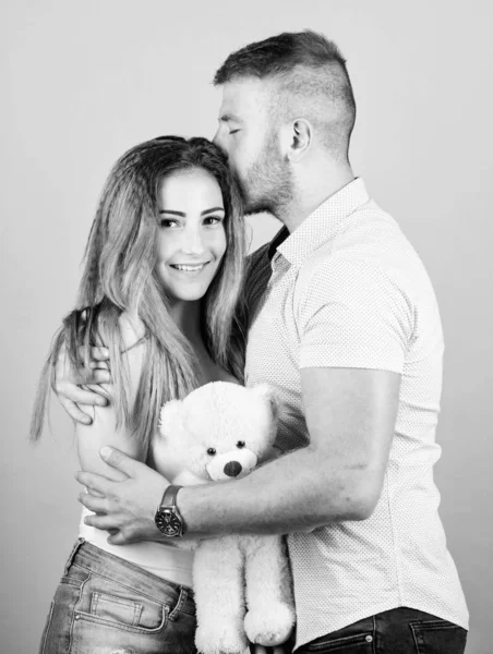 Family love. Romantic surprise. Man and pretty girl in love. Guy and girl cuddling. Enjoying each other. Happy family. Valentines day holiday. Soft toy teddy bear gift. Man and woman couple in love — Stock Photo, Image