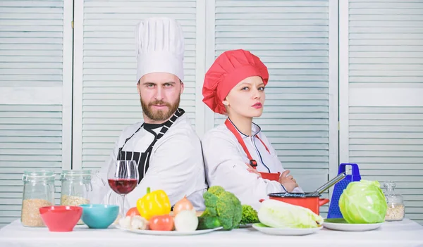 Cooking with your spouse can strengthen relationships. Woman and bearded man culinary partners. Ultimate cooking challenge. Reasons why couples cooking together. Couple compete in culinary arts