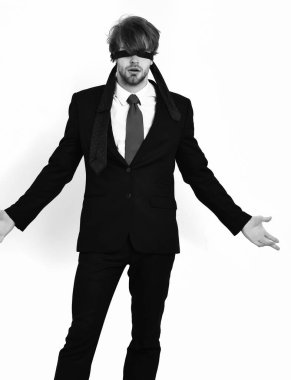 Sakallı, maço, şık takım elbiseli, gözleri bağlı bir adam.