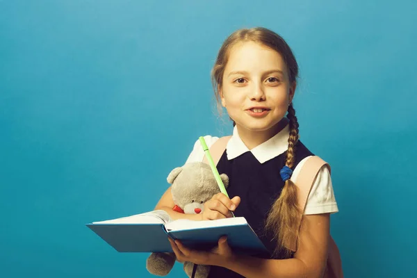 Mädchen mit Zöpfen und glücklichem Gesicht. Kind in Schuluniform — Stockfoto