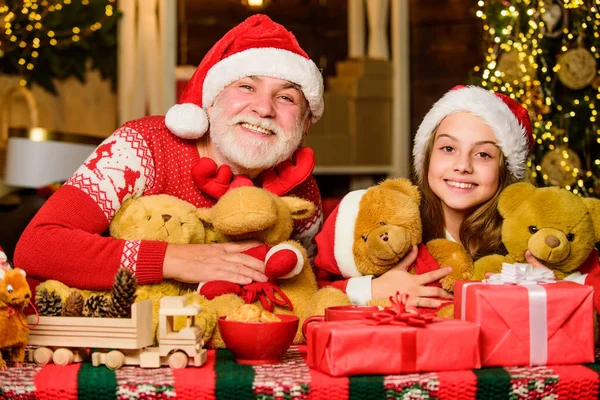 Happy childhood. Gift surprise. Gift teddy bear toy for kid. Boxing day. Family values. Lovely gift. Child enjoy christmas with grandfather Santa claus. Festive tradition. Happiness and joy