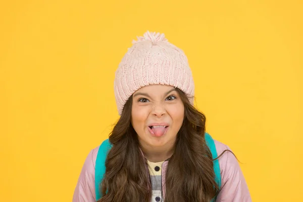 Ugh, yuck. Little schoolchild stick tongue. Little kid make grimace yellow background. Little girl back to school. Little child with autumn look — Stock Photo, Image