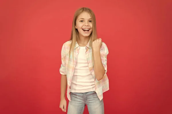 Feeling awesome. Positive emotions concept. Happy childrens day. Being happy every day. Schoolgirl casual style emotional kid. Happy childhood. Girl child smiling face expression on red background — Stock Photo, Image