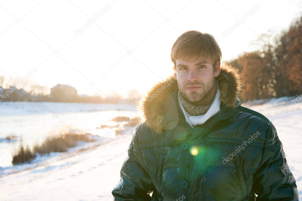 Feeling rested. cold and flu. male in down coat with fur hood. feel warm and comfortable. favorite season. handsome guy green puffer coat. man enjoy sunny winter day. male seasonal fashion