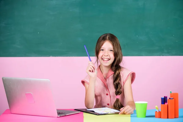 Studying atmosphere. Online education. Working on project. small girl pupil with laptop. childhood study online. knowledge day. 4G internet for weblog. smart school girl in classroom. back to school — 图库照片