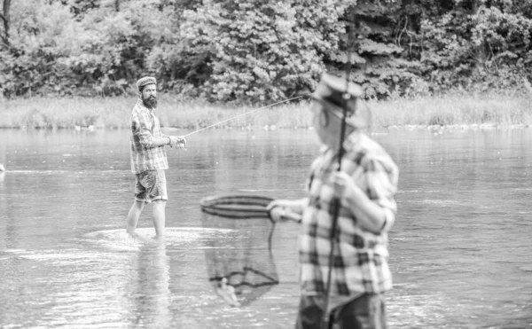 Fishing freshwater lake pond river. Bearded men catching fish. Mature man with friend fishing. Summer vacation. Life is always better when I am fishing. Fisherman with fishing rod. Activity and hobby