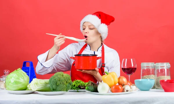 Easy ideas for christmas party. Woman chef santa hat cooking hold wooden spoons. Best christmas recipes. Christmas dinner idea. Cooking for family. Try main meal. Healthy christmas holiday recipes
