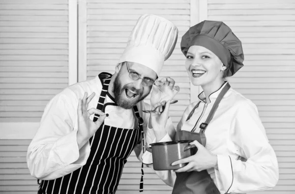 Enjoying happy moments. couple in love with perfect food. Family cooking in kitchen. secret ingredient by recipe. cook uniform. Menu planning. culinary cuisine. man and woman chef in restaurant