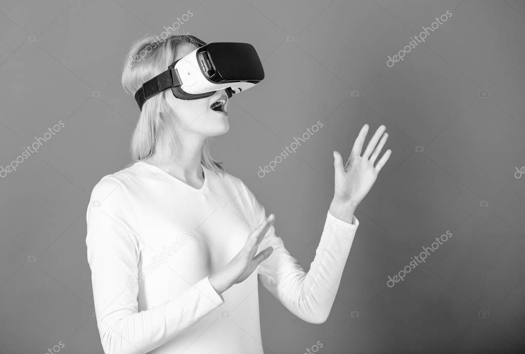 Young woman using a virtual reality headset with conceptual network lines. Woman using VR device. Cheerful smiling woman looking in VR glasses. Cyber.