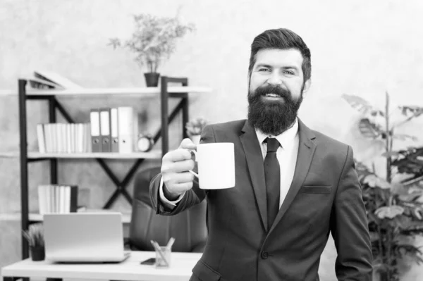 Drinking coffee relaxing break. Boss enjoying energy drink. Successful people drink coffee. Caffeine addicted. Start day with coffee. Man bearded businessman hold coffee cup stand office background