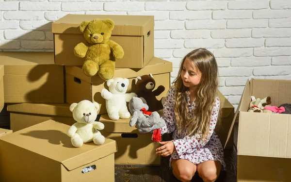 You are sure to love it. Cardboard boxes - moving to new house. happy child cardboard box. happy little girl with toy. playing into new home. new apartment. purchase of new habitation — Stock Photo, Image
