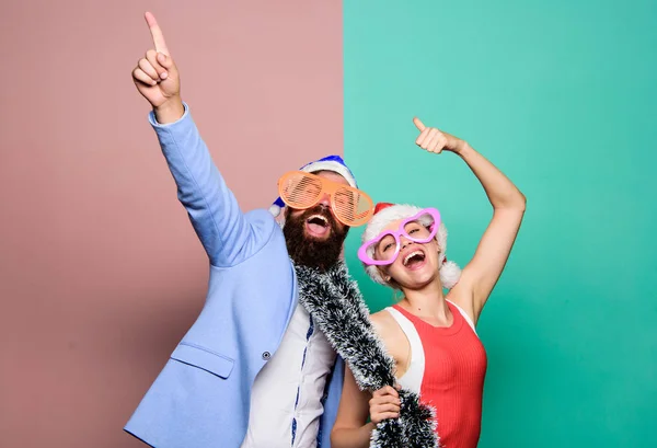 Christmas party office. Winter corporate party. Office christmas party. Happy man and woman wear santa hats and funny sunglasses. Manager tinsel celebrate new year. Corporate holiday party ideas