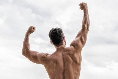 Victory and success. Champion and winner concept. Man celebrating success. Bodybuilder strong muscular body feeling powerful and superior rear view. Achieve success. Great shape. Successful athlete