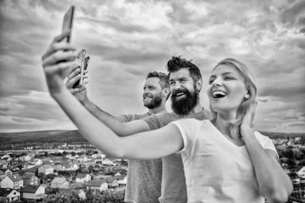 Girl and man with mobile smartphones communication online. Selfie time. Life online. People taking selfie or streaming online video. Mobile internet and social networks. Mobile dependency problem