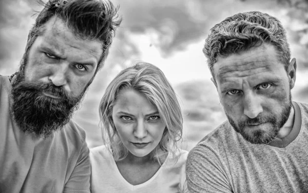 Suspicious look. They know what you did. Threesome suspiciously look down. Woman and men look confident sky background. Strength in unity. Stand up for their position. Group people suspect you