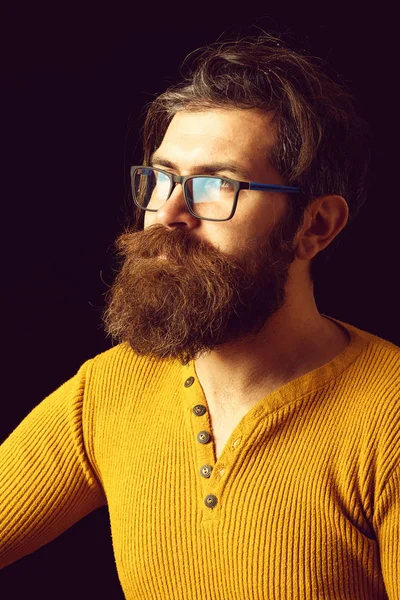 Serious hipster man in glasses in studio on black background — Stock Photo, Image