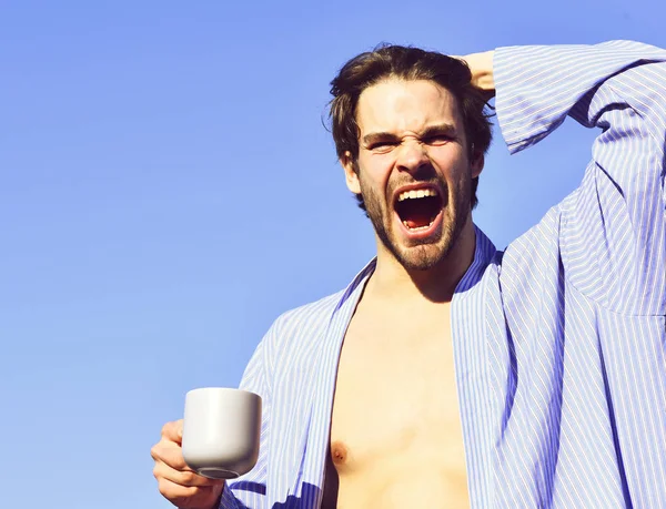 Caucásico macho en azul rayas pijama celebración taza — Foto de Stock