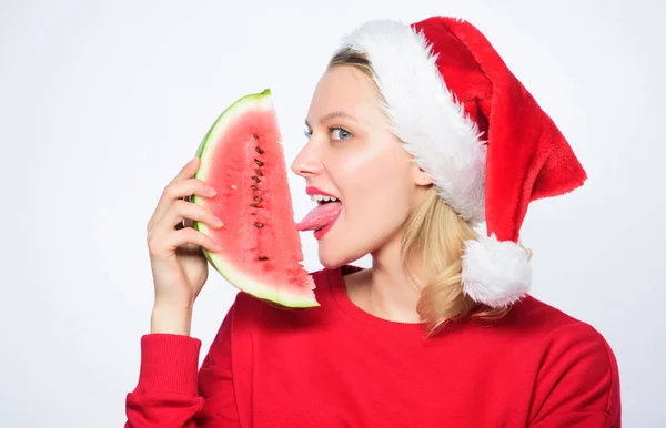Delicious christmas concept. Christmas summer destinations. Christmas girl eat watermelon. Woman santa hat hold slice watermelon. Prolong summer. Travel christmas vacation and holidays resort