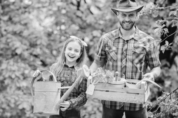 Family farm. spring village country. ecology. Watering can and shovel. little girl and happy man dad. earth day. father and daughter on ranch. Beautiful florist at work. hello summer — Stock Photo, Image