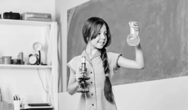 自信的医生带实验室烧瓶的小女孩学校实验室。现代技术。女孩学习化学与试管。科学课与显微镜。回到学校生物教育 — 图库照片