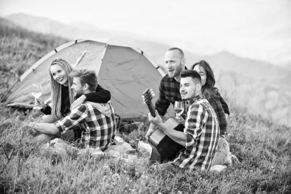 Friends enjoy vacation. Pleasant hike picnic. People eating food. Hike picnic. Camping concept. Youth having fun picnic in highlands. Summer adventures. Group friends relaxing picnic in mountains