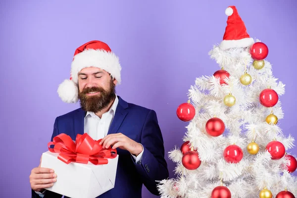 open it. bearded man presents from santa. successful businessman reward at new year party. man celebrate business success near xmas tree. happy holidays. winter season sales. christmas shopping